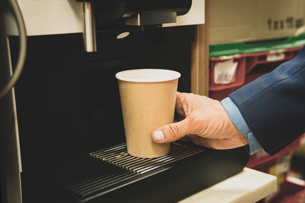 Man,Takes,Coffee,From,A,Vending,Machine.,Cropped,View,Of